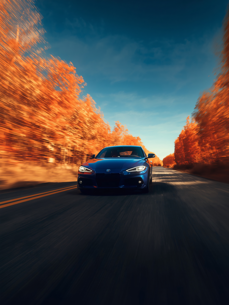 Red sports car on the road at sunset